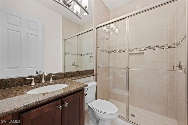 bathroom with vanity, toilet, and walk in shower