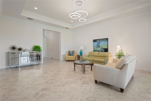 living room featuring crown molding, a raised ceiling, and a chandelier