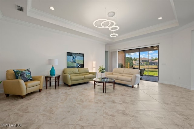 tiled living room with crown molding, an inviting chandelier, and a tray ceiling