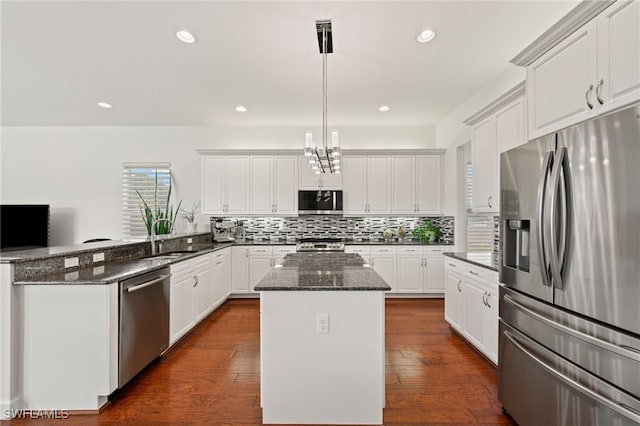 kitchen with pendant lighting, white cabinetry, and appliances with stainless steel finishes