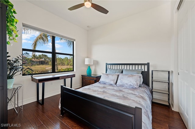 bedroom with dark hardwood / wood-style floors