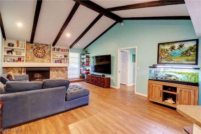 living room with high vaulted ceiling, a stone fireplace, light hardwood / wood-style floors, and beamed ceiling