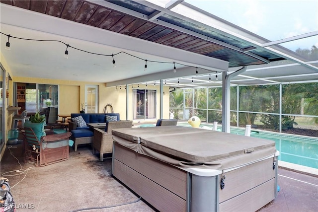 view of patio / terrace featuring a hot tub, an outdoor hangout area, and a lanai