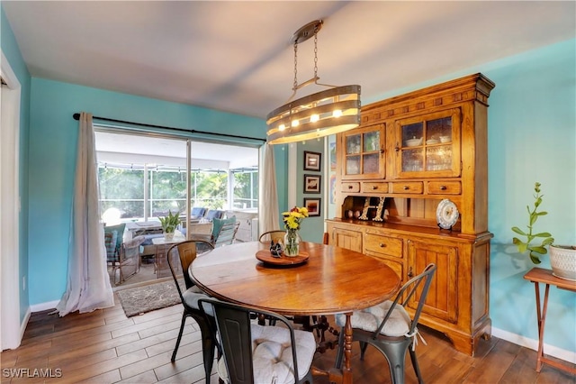 dining space featuring dark wood-type flooring