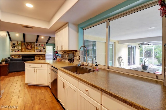 kitchen featuring sink, light hardwood / wood-style floors, white cabinets, and dishwasher