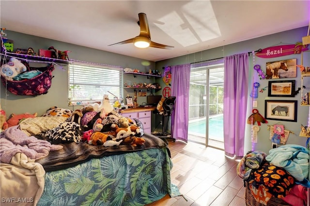 bedroom featuring access to exterior, ceiling fan, and light hardwood / wood-style floors