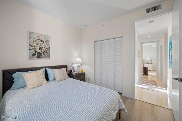 bedroom featuring a closet and light hardwood / wood-style flooring