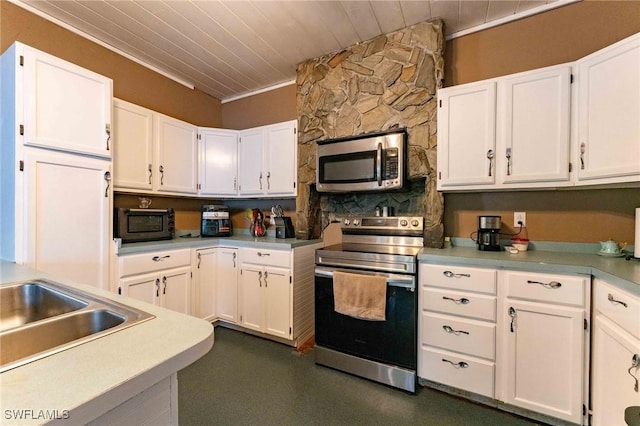 kitchen with ornamental molding, stainless steel appliances, wooden ceiling, and white cabinets