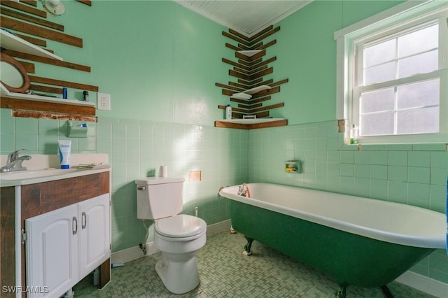 bathroom featuring vanity, tile walls, a bathtub, and toilet