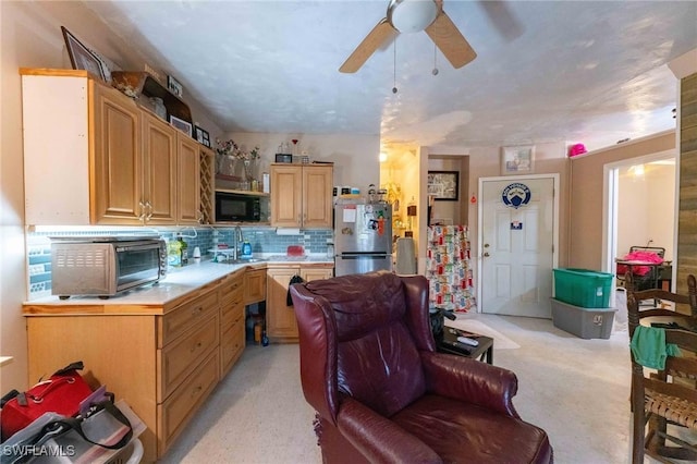 kitchen featuring decorative backsplash, stainless steel fridge, and ceiling fan