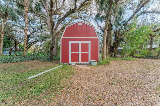 view of outbuilding featuring a yard