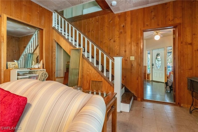 stairway featuring wooden walls