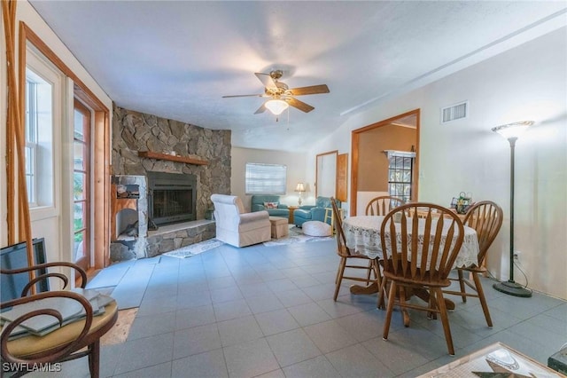 interior space featuring a stone fireplace and ceiling fan