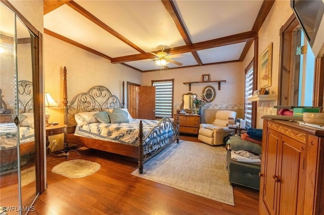 bedroom with hardwood / wood-style flooring, coffered ceiling, and multiple windows