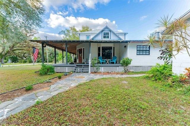 rear view of house featuring a yard and covered porch