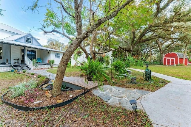 view of yard with a shed and covered porch