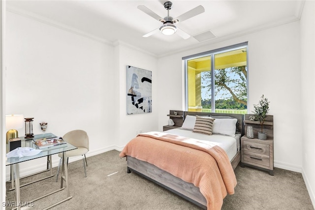 carpeted bedroom featuring ornamental molding and ceiling fan