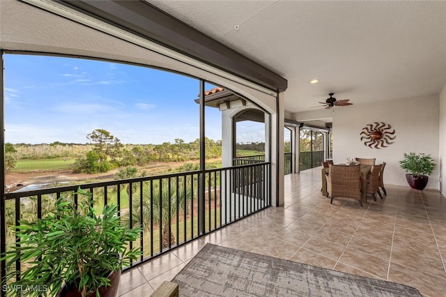 view of patio / terrace with ceiling fan and a balcony