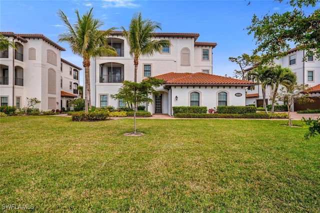 mediterranean / spanish house featuring a front lawn