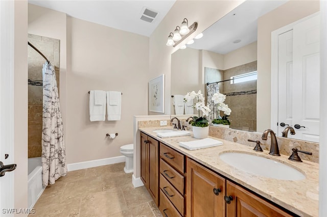 full bathroom featuring vanity, shower / tub combo, and toilet