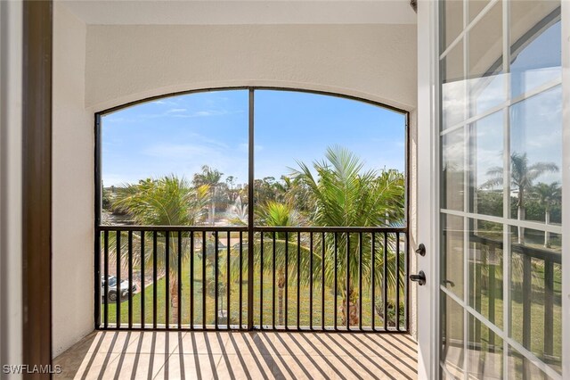 unfurnished sunroom with a water view