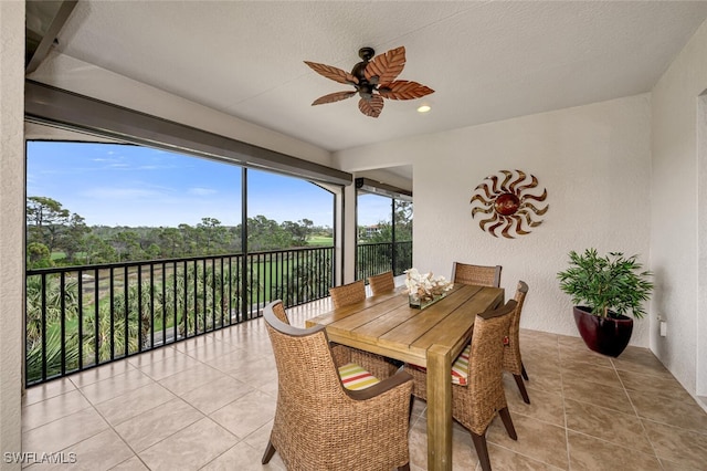 sunroom featuring ceiling fan