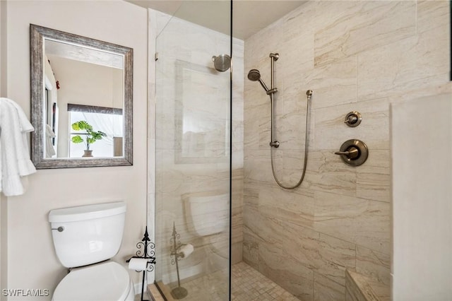 bathroom featuring walk in shower and toilet