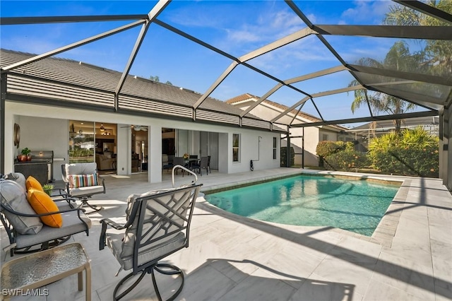 pool featuring a lanai and a patio area