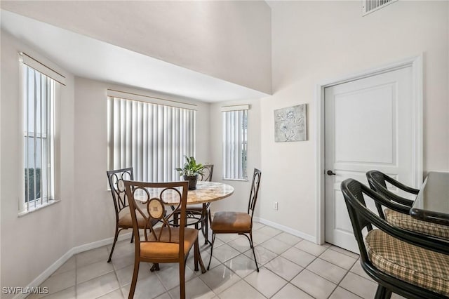 dining area featuring light tile patterned floors, visible vents, and baseboards