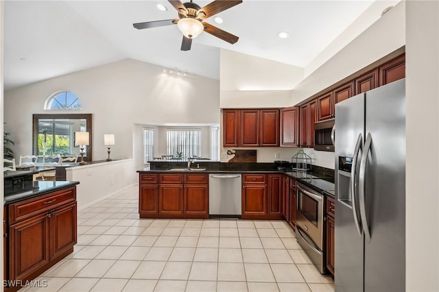 kitchen with light tile patterned floors, ceiling fan, stainless steel appliances, dark brown cabinets, and a sink