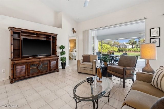 living area with light tile patterned floors, ceiling fan, and lofted ceiling