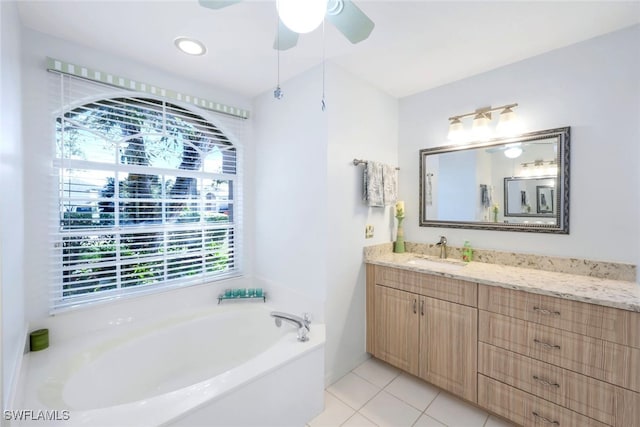 bathroom with vanity, a bathtub, tile patterned floors, and ceiling fan