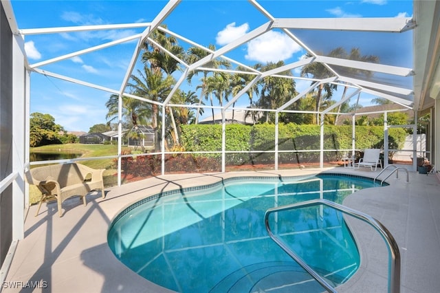 view of swimming pool featuring a water view, a lanai, and a patio