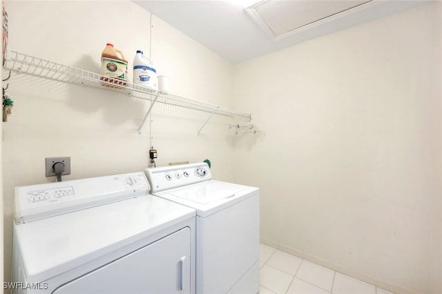 laundry area featuring washer and clothes dryer and light tile patterned flooring