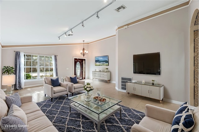 living room with a notable chandelier, crown molding, rail lighting, and tile patterned floors