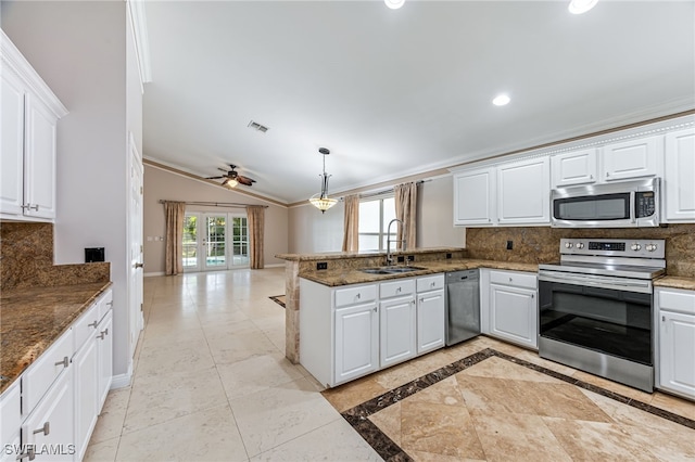 kitchen with sink, white cabinetry, kitchen peninsula, stainless steel appliances, and backsplash