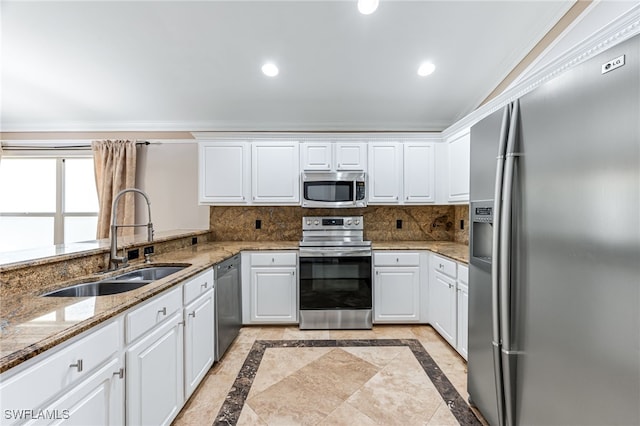 kitchen with sink, decorative backsplash, stainless steel appliances, and white cabinets