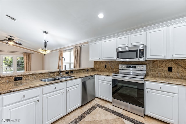 kitchen with appliances with stainless steel finishes, sink, decorative backsplash, and white cabinets