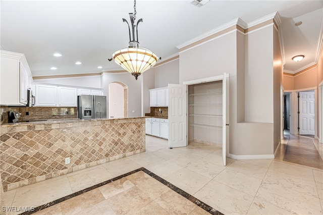 kitchen with tasteful backsplash, light stone counters, ornamental molding, appliances with stainless steel finishes, and white cabinets