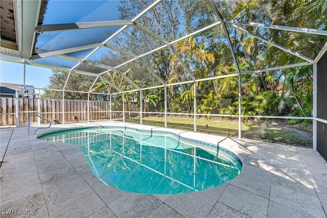 view of pool featuring a patio area and glass enclosure