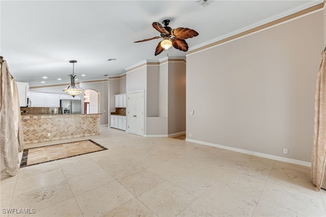 unfurnished living room featuring ceiling fan and ornamental molding