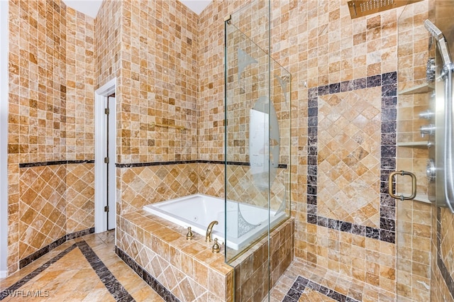 bathroom with separate shower and tub and tile walls