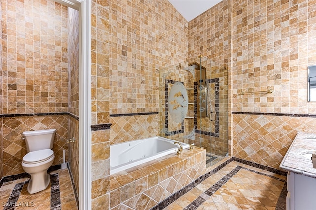 full bathroom with tile walls, vanity, and independent shower and bath