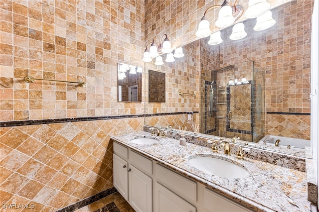 bathroom featuring vanity, tile walls, and a shower with shower door