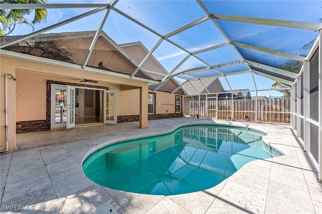 view of pool with a patio, a lanai, and ceiling fan