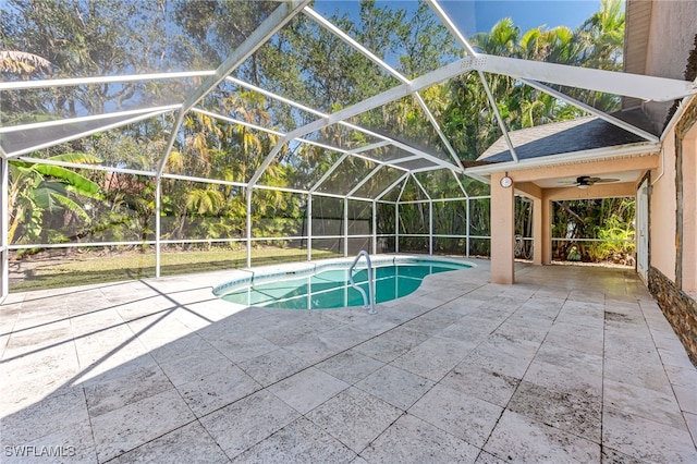 view of swimming pool featuring a lanai, a patio area, and ceiling fan