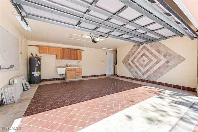 garage with sink, a garage door opener, and electric water heater