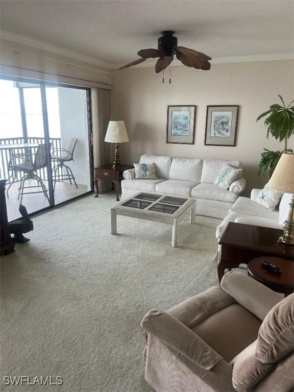 carpeted living room with ornamental molding, a textured ceiling, and ceiling fan