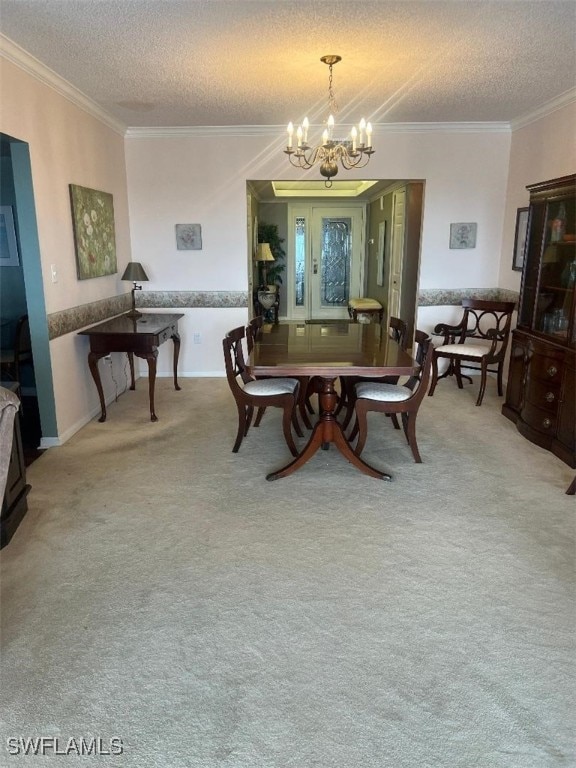 carpeted dining area featuring crown molding, a textured ceiling, and a chandelier