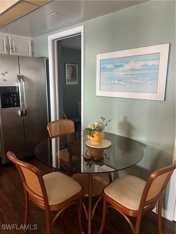 dining room with dark hardwood / wood-style flooring